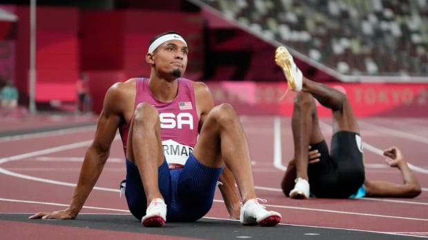 Michael Norman sits on the track after taking fifth in the men's 400 meter Olympic final.